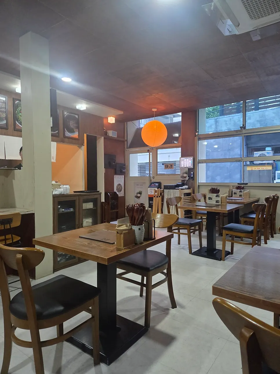 Interior with solo bar seating and tables for 2–4