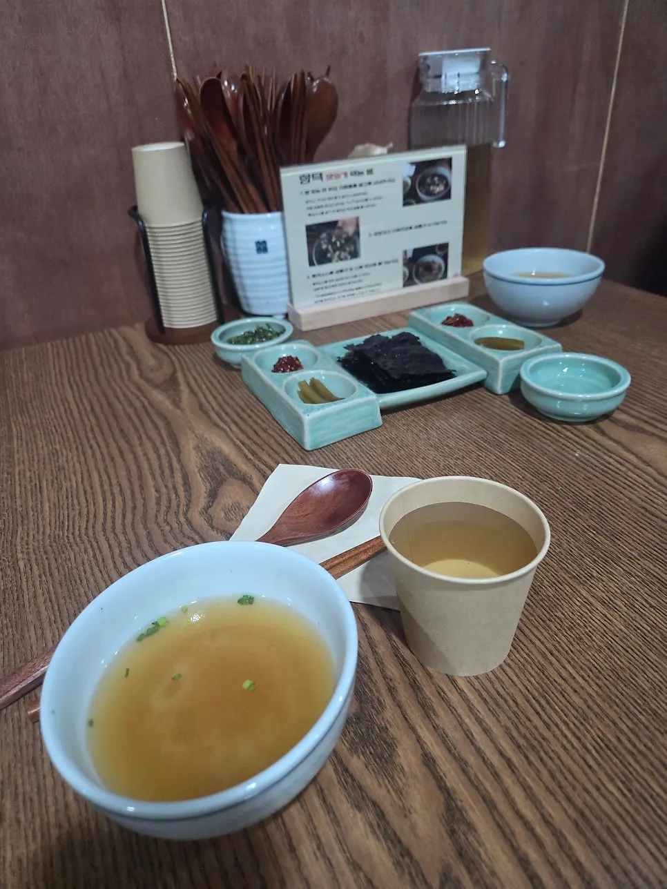 Basic table setting with doenjang soup, gopchang gim, bibim jeotgal, and jangajji