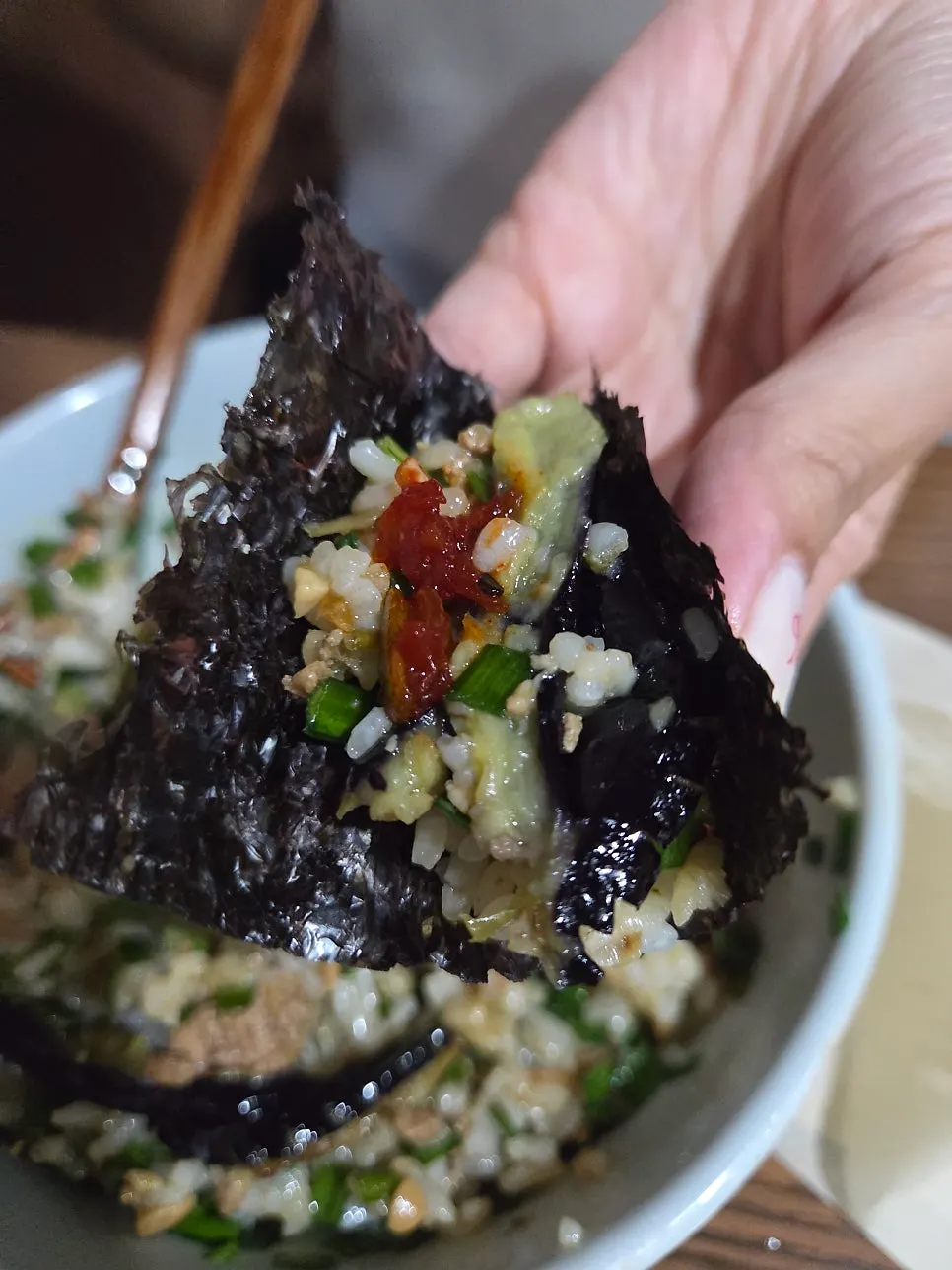 Wrapping rice and bibim jeotgal in gopchang gim