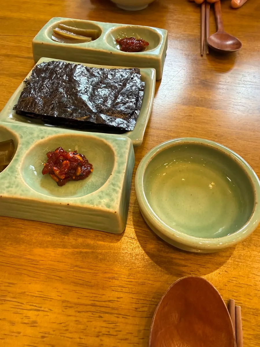 Basic table setting with doenjang soup, bibim jeotgal, and gim