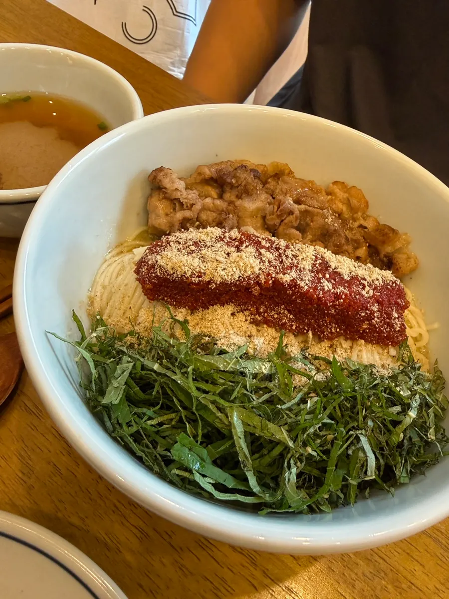Full table of eggplant doenjang rice bowl, deodeok mushrooms, and herring roe bibim noodles