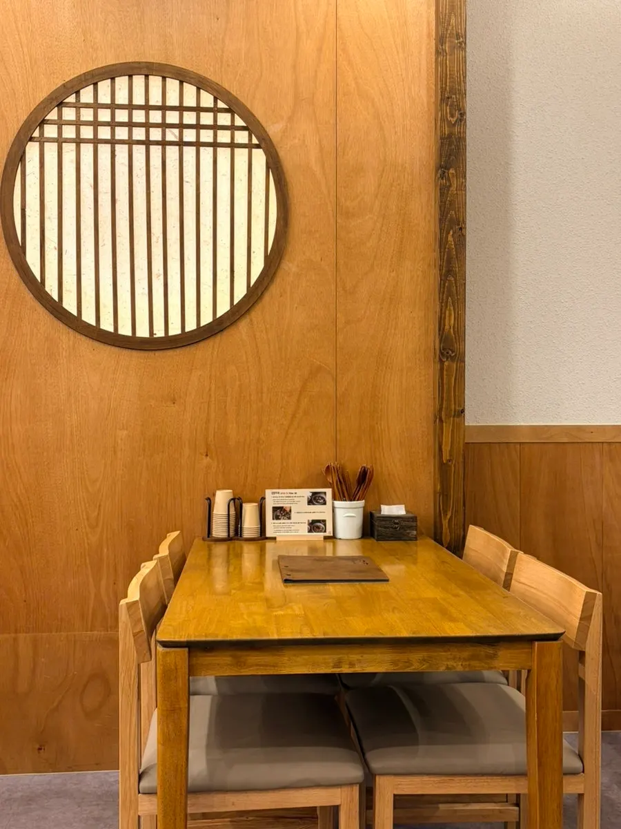 A corner of the restaurant with tables for four