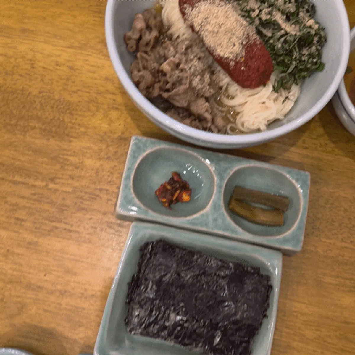 Full spread of eggplant doenjang rice bowl and herring roe bibim noodles
