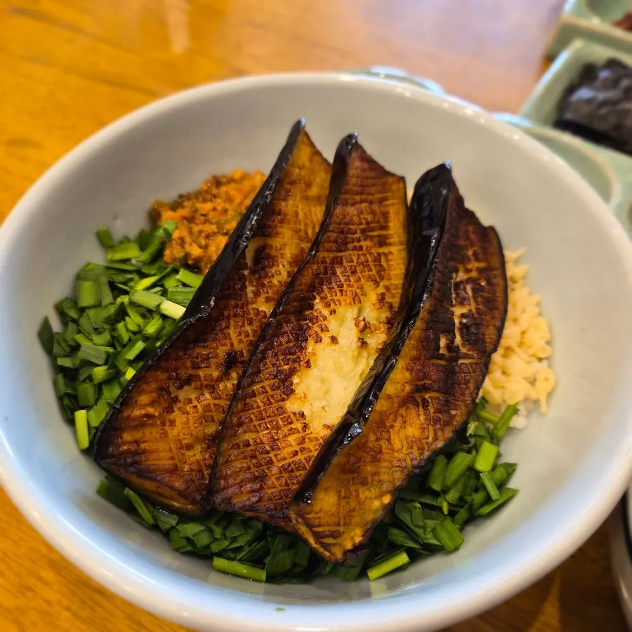Eggplant doenjang rice bowl topped with grilled eggplant