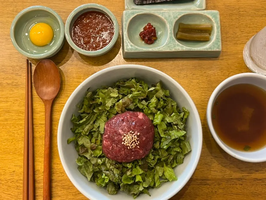 Yukhoe bibimbap topped with egg yolk