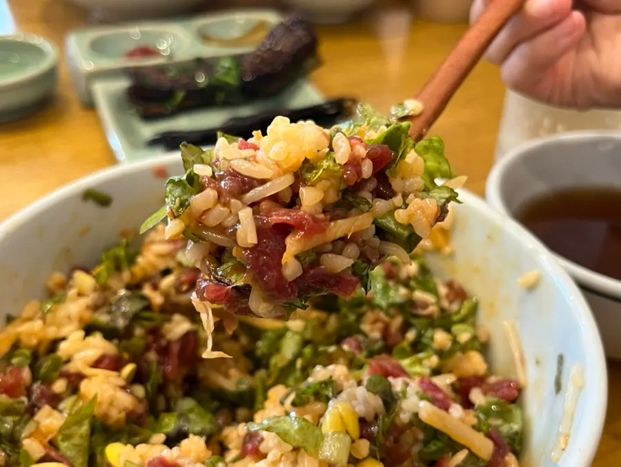 Yukhoe bibimbap mixed with sauce and egg yolk