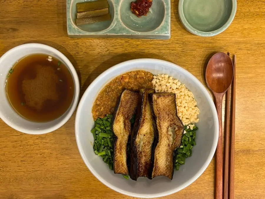 Eggplant miso rice bowl topped with three pieces of eggplant