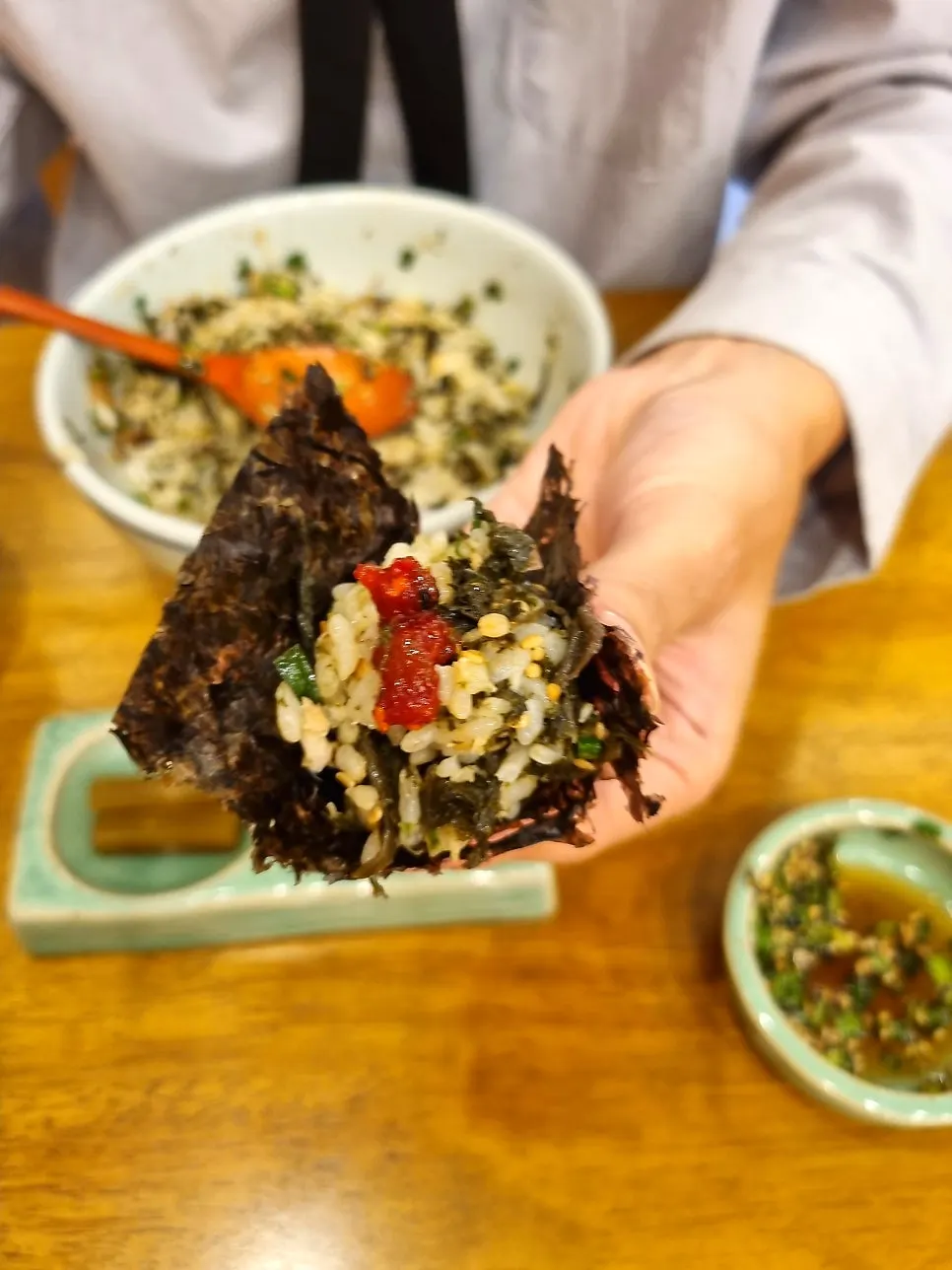 Wrapping rice and mushroom jeotgal in gopchang gim