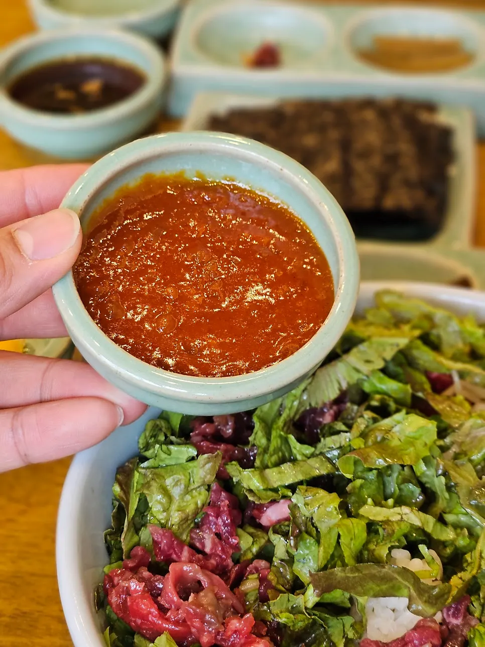 Yukhoe bibimbap piled high with lettuce