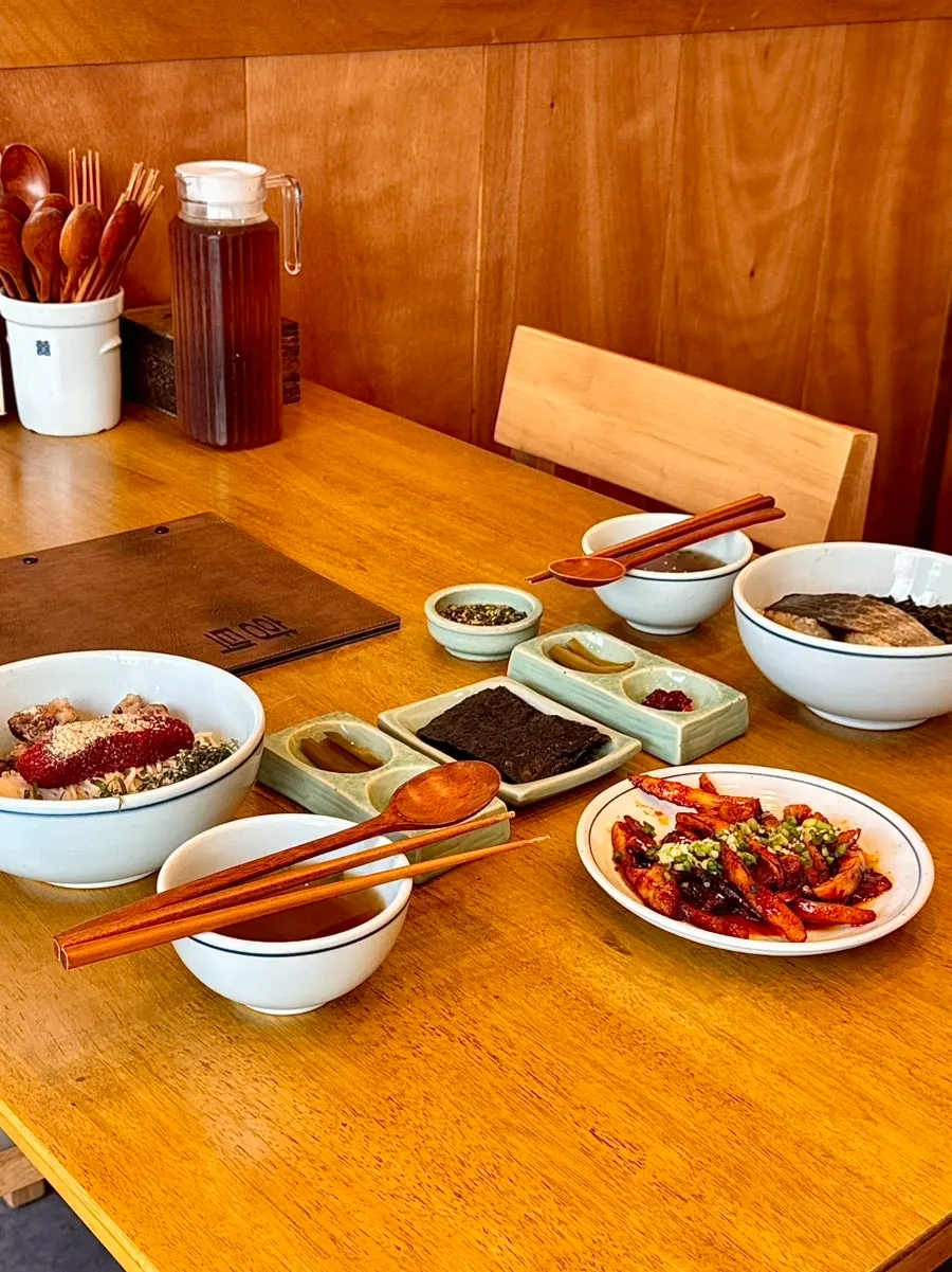 Mackerel gondre rice and herring roe bibim noodles table setting at Hyangtaek Jeonpo Branch
