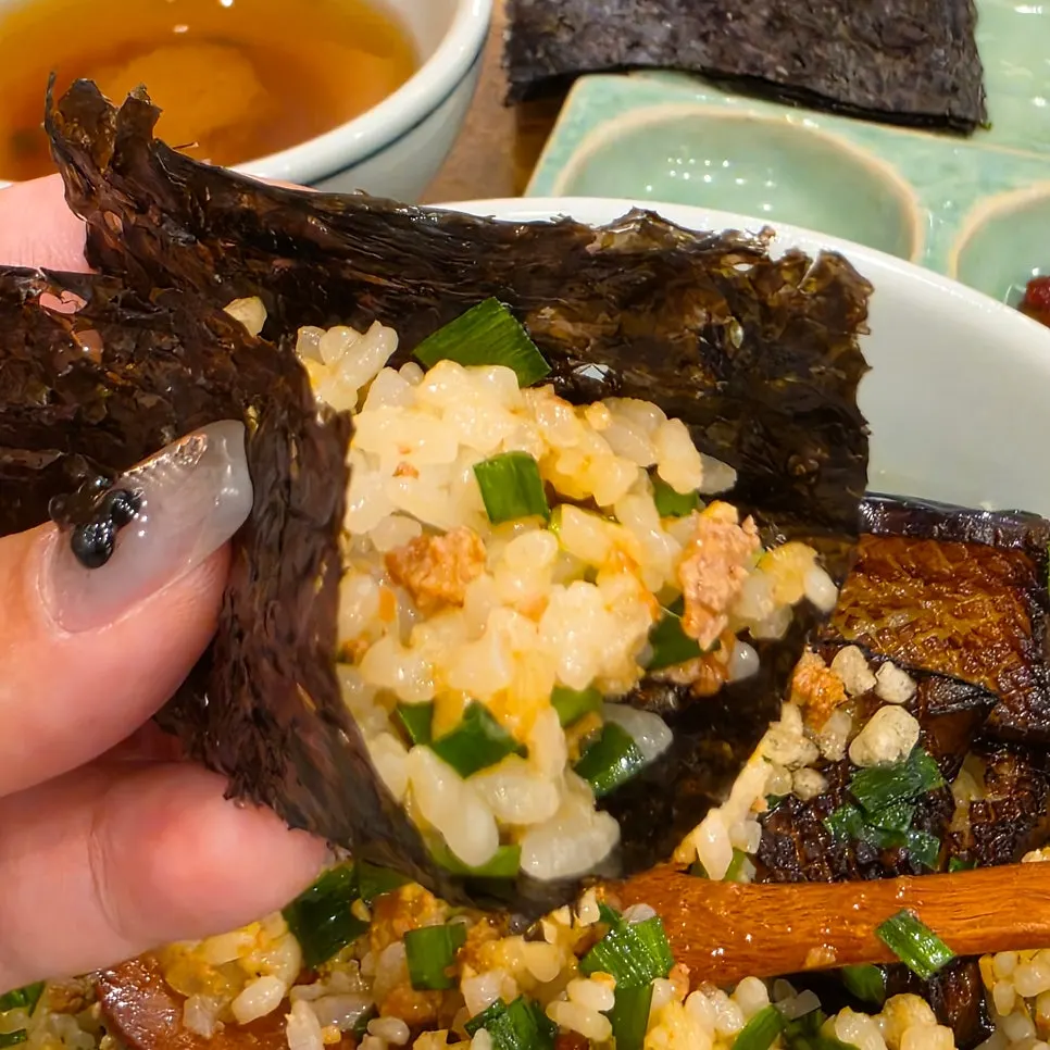 Wrapping rice and eggplant in raw gim