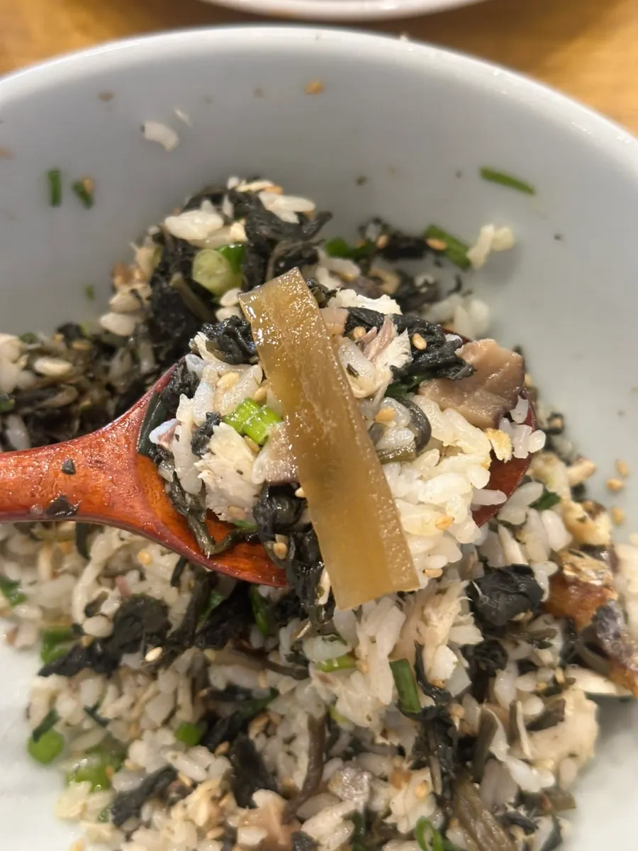Close-up of mackerel gondre rice and side dishes