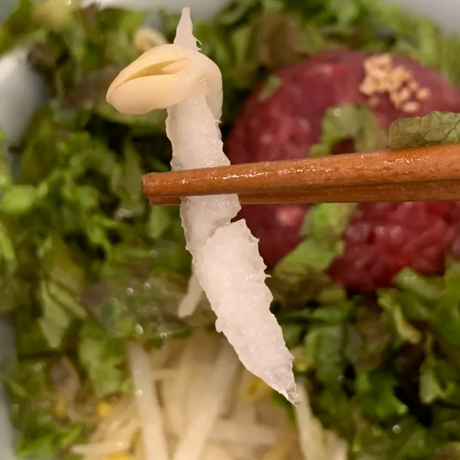 Bean sprouts and pear revealed inside the yukhoe bibimbap