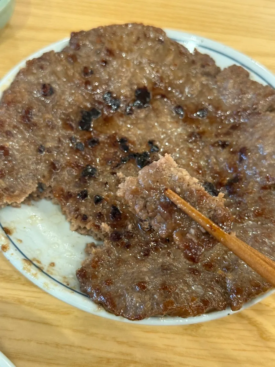 A piece of grilled ribs coated in sauce