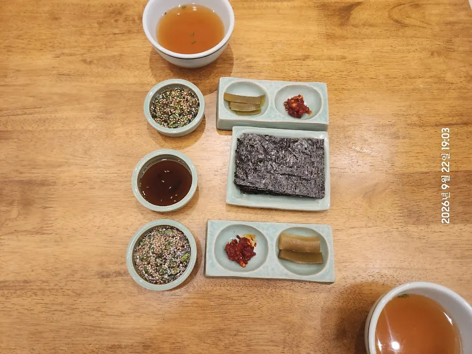 Side dish spread with gopchang gim, jeotgal, and sauces