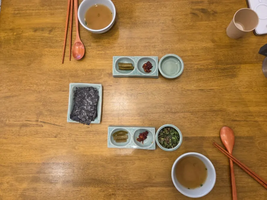 Table spread with ordered mackerel gondre rice and eggplant doenjang rice