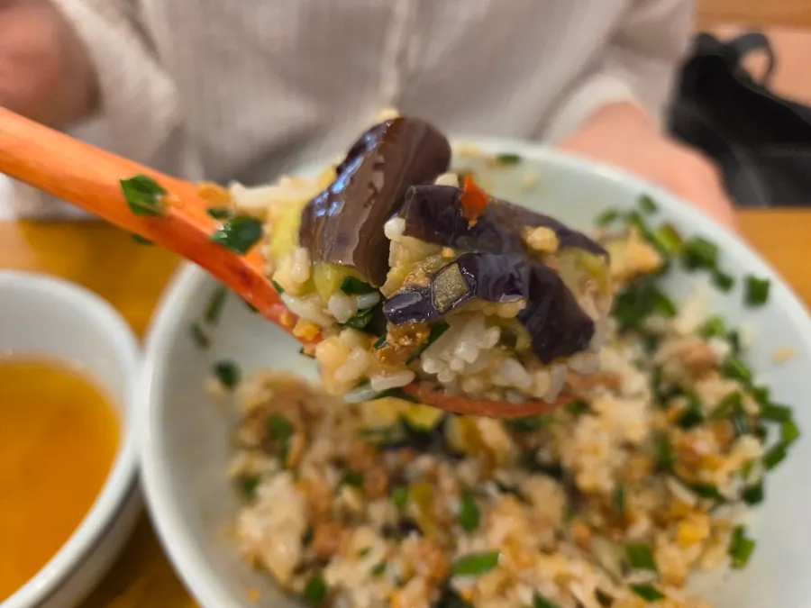 Spoonful of well-cooked eggplant in doenjang sauce with rice