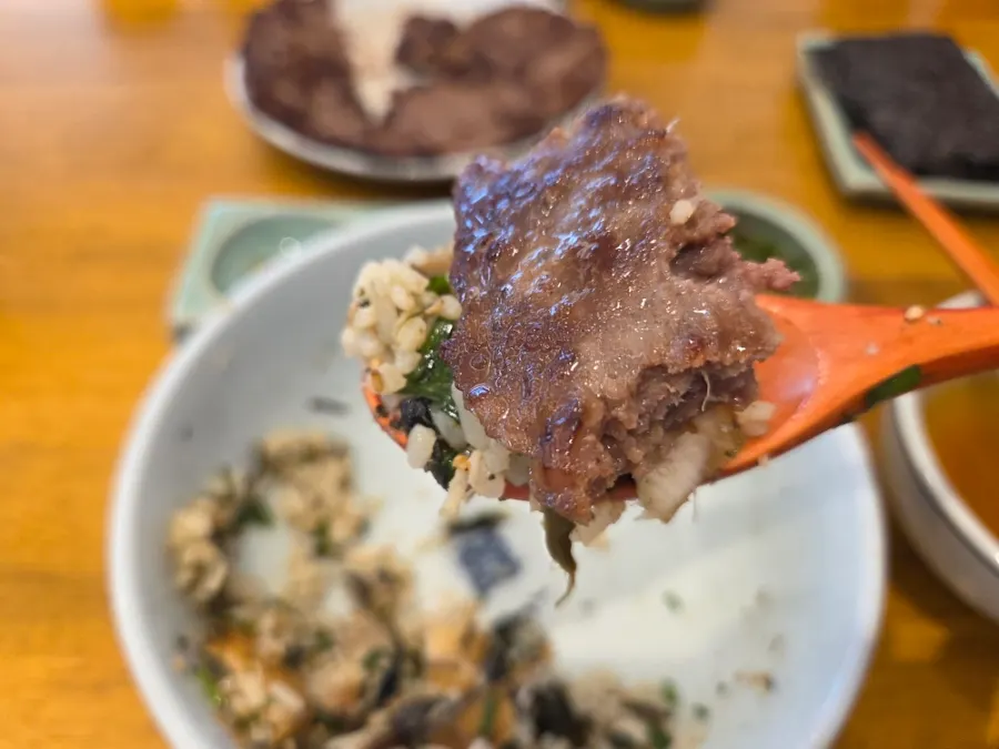 A piece of galbi eaten together with rice