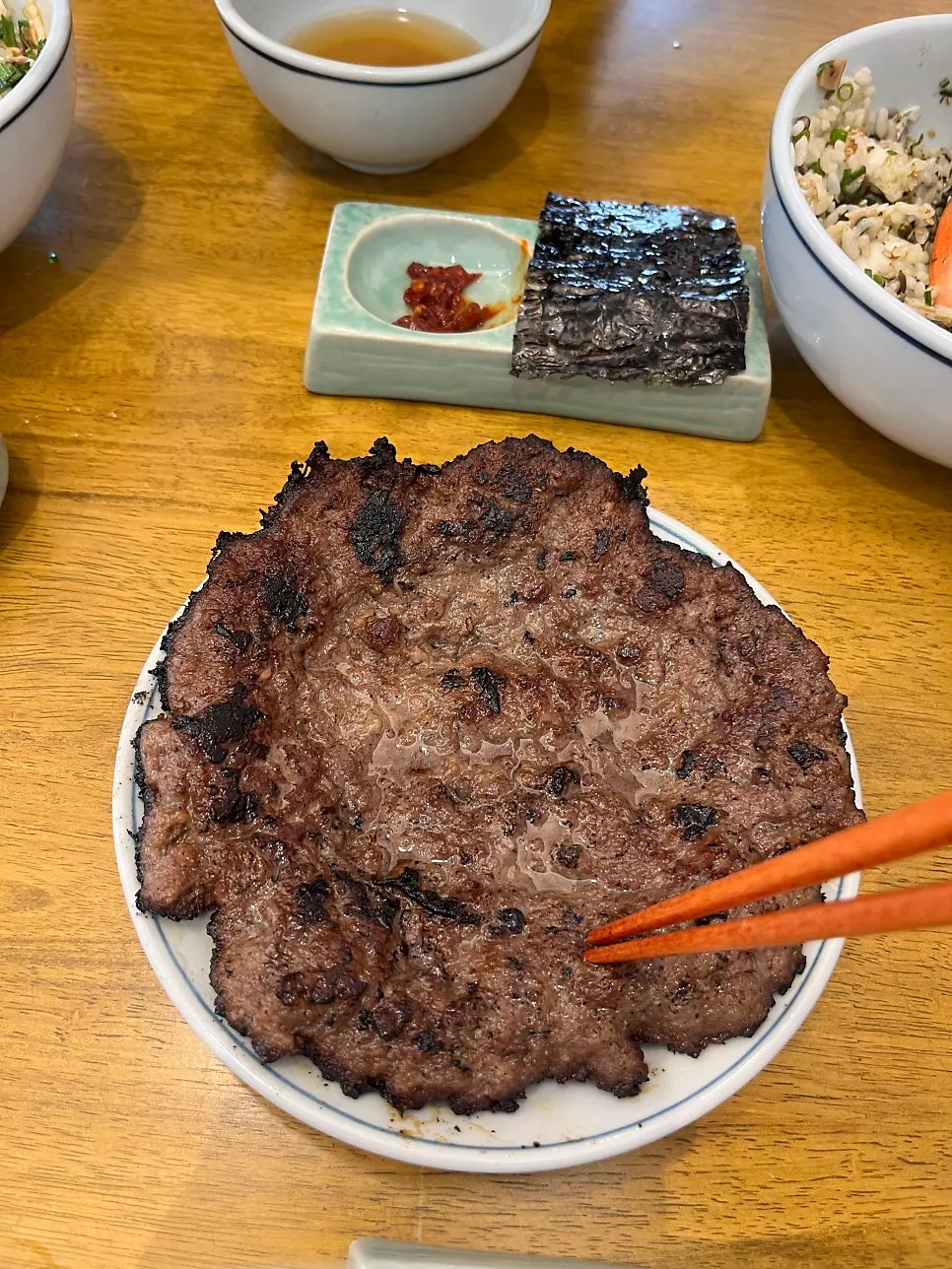 A piece of galbi placed on top of the rice bowl