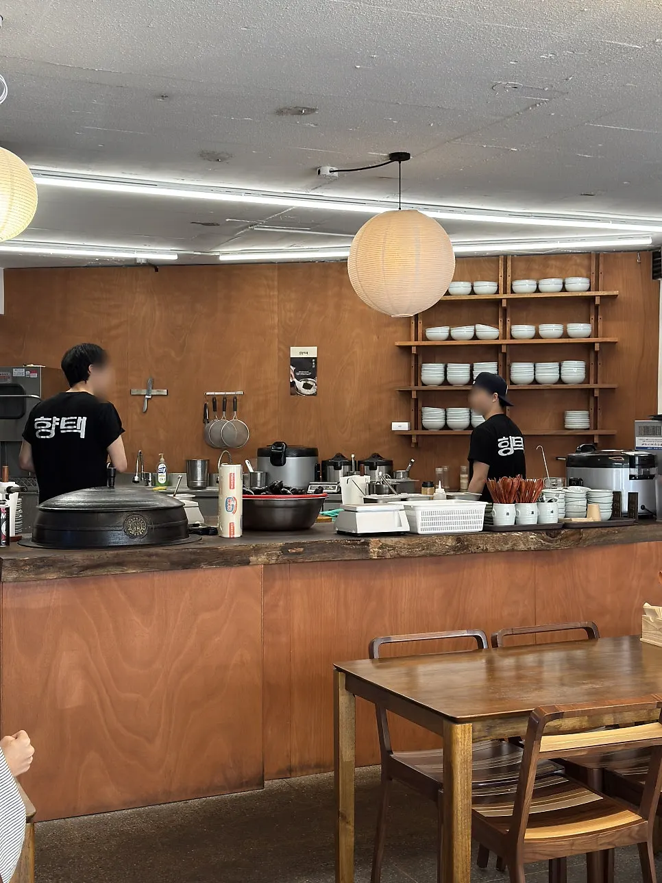Open kitchen with white dishware neatly arranged at Hyangtaek Daebong Branch