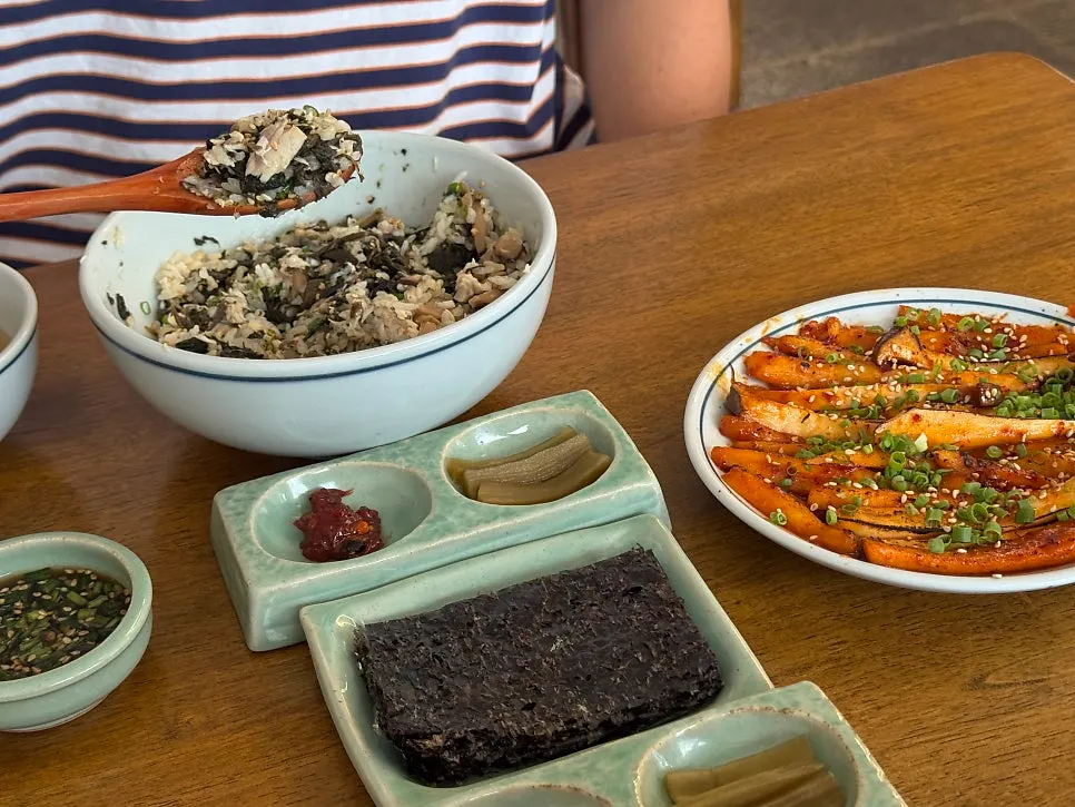 Table setting with gopchang gim, bibim jeotgal, and side dishes