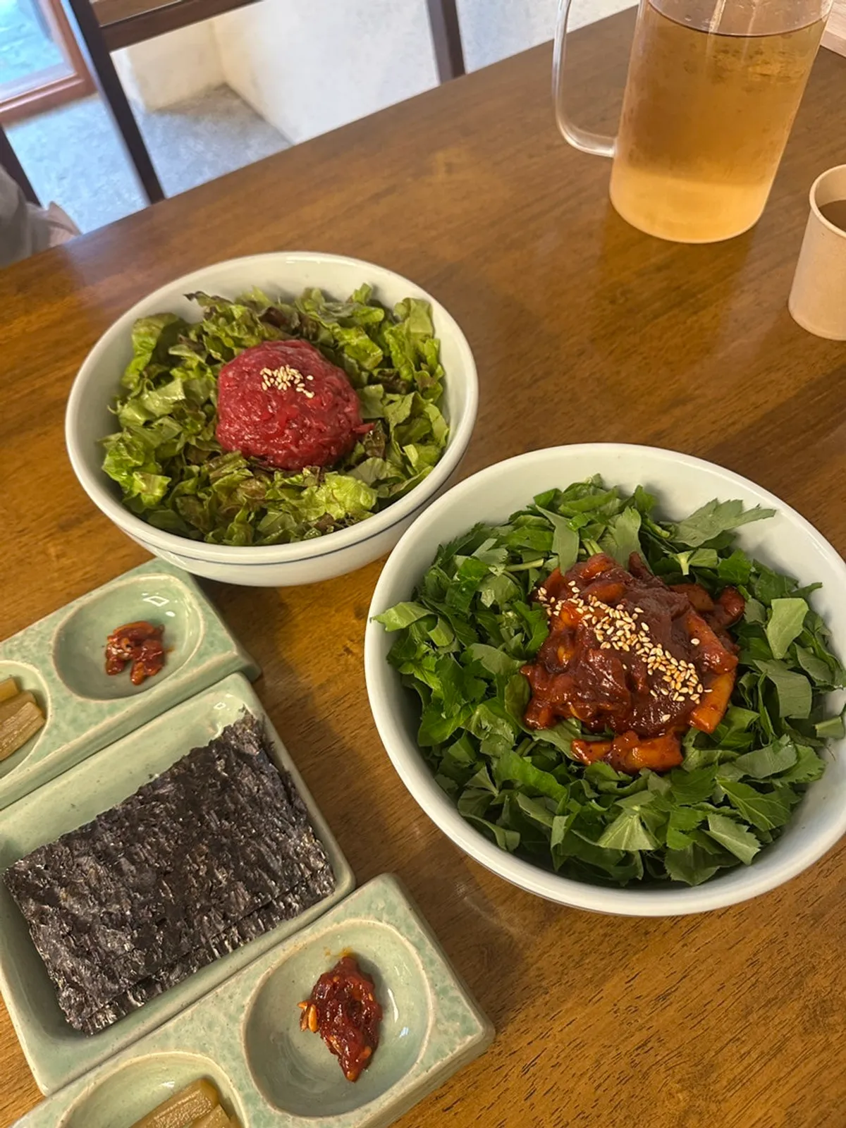 Table set with chamnamul squid rice bowl and yukhoe bibimbap