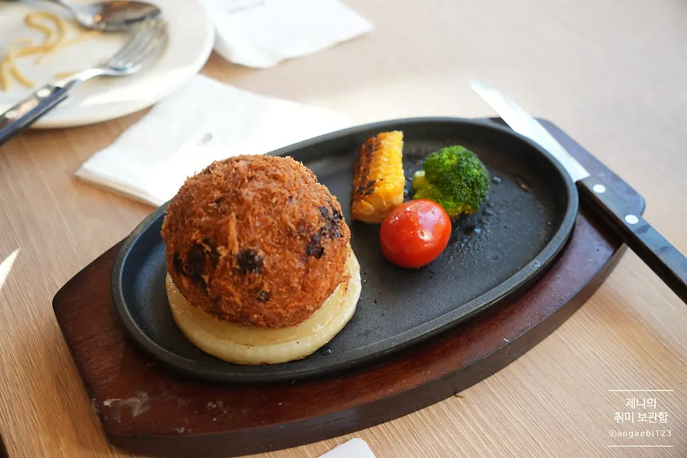 Sizzling cheese cutlet served over onions