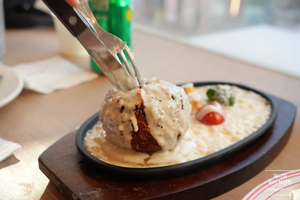 Cutting the sizzling cheese cutlet with a knife