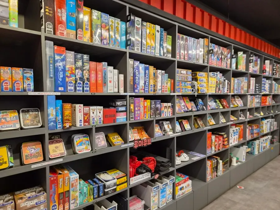 Board game shelf organized by difficulty and genre