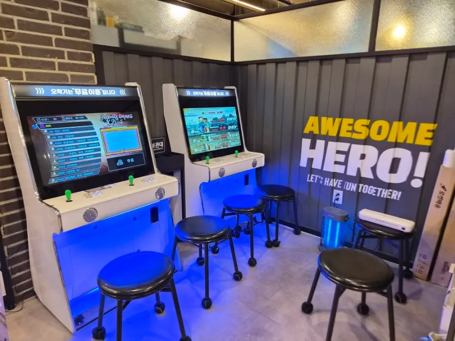Pool table and arcade machines on one side of the store
