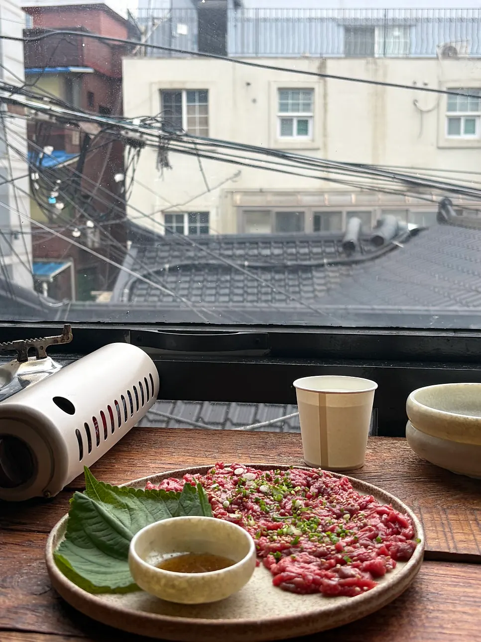 Beef tartare served alongside beer on the table