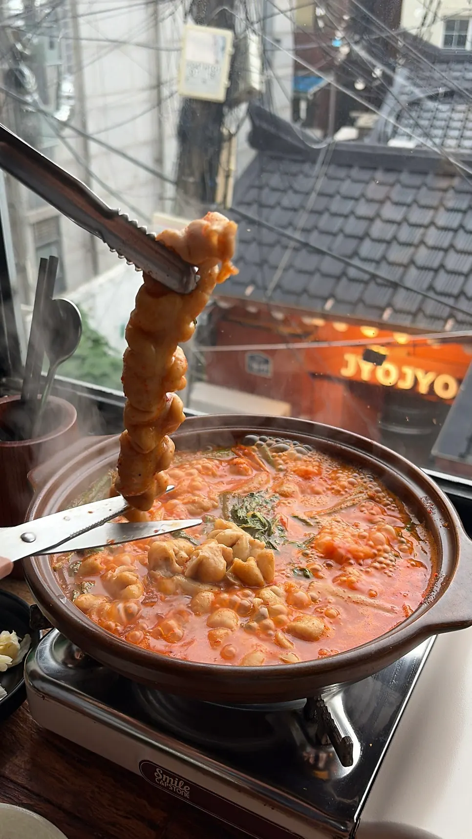 Gopchang revealing itself inside the stew as it boils