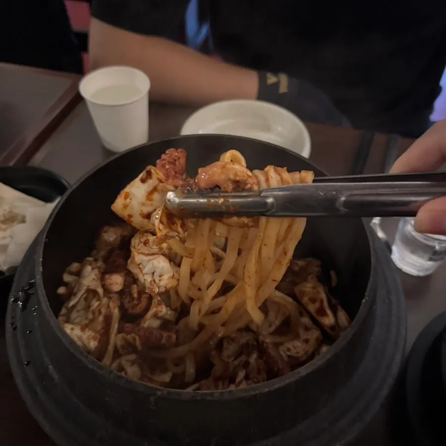 Springy knife-cut octopus lifted with chopsticks
