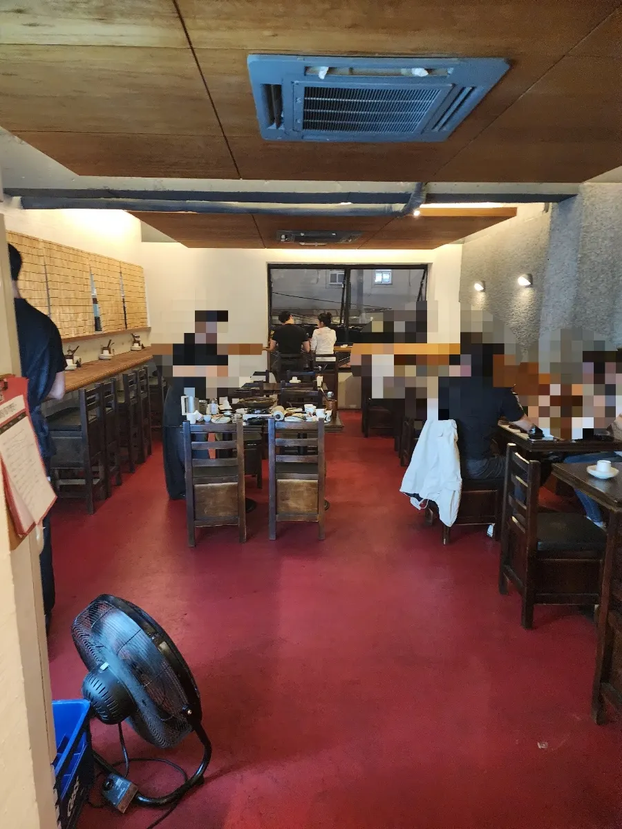 Main hall with wood-toned tables and bar seating