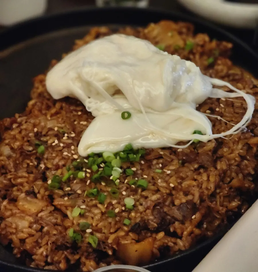 Beef belly kimchi fried rice mixed with poured-in cheese