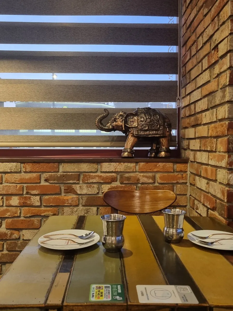 Dining table with curry, naan and lassi