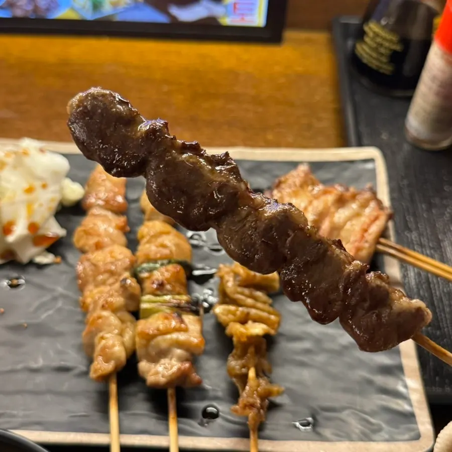 Golden-brown grilled chicken wing skewer
