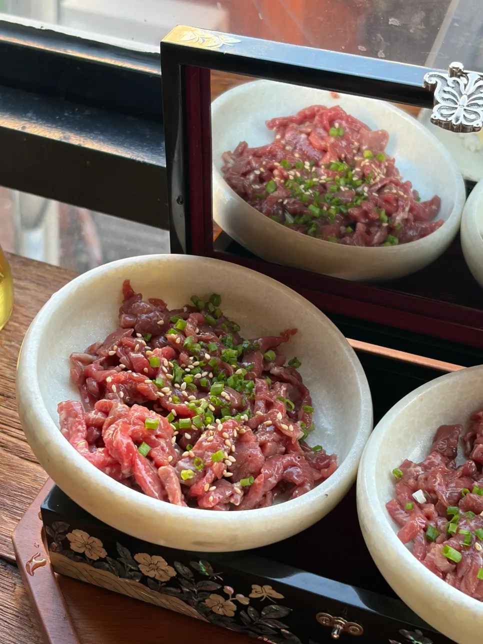 Two plates of tartare and aged kimchi egg sushi