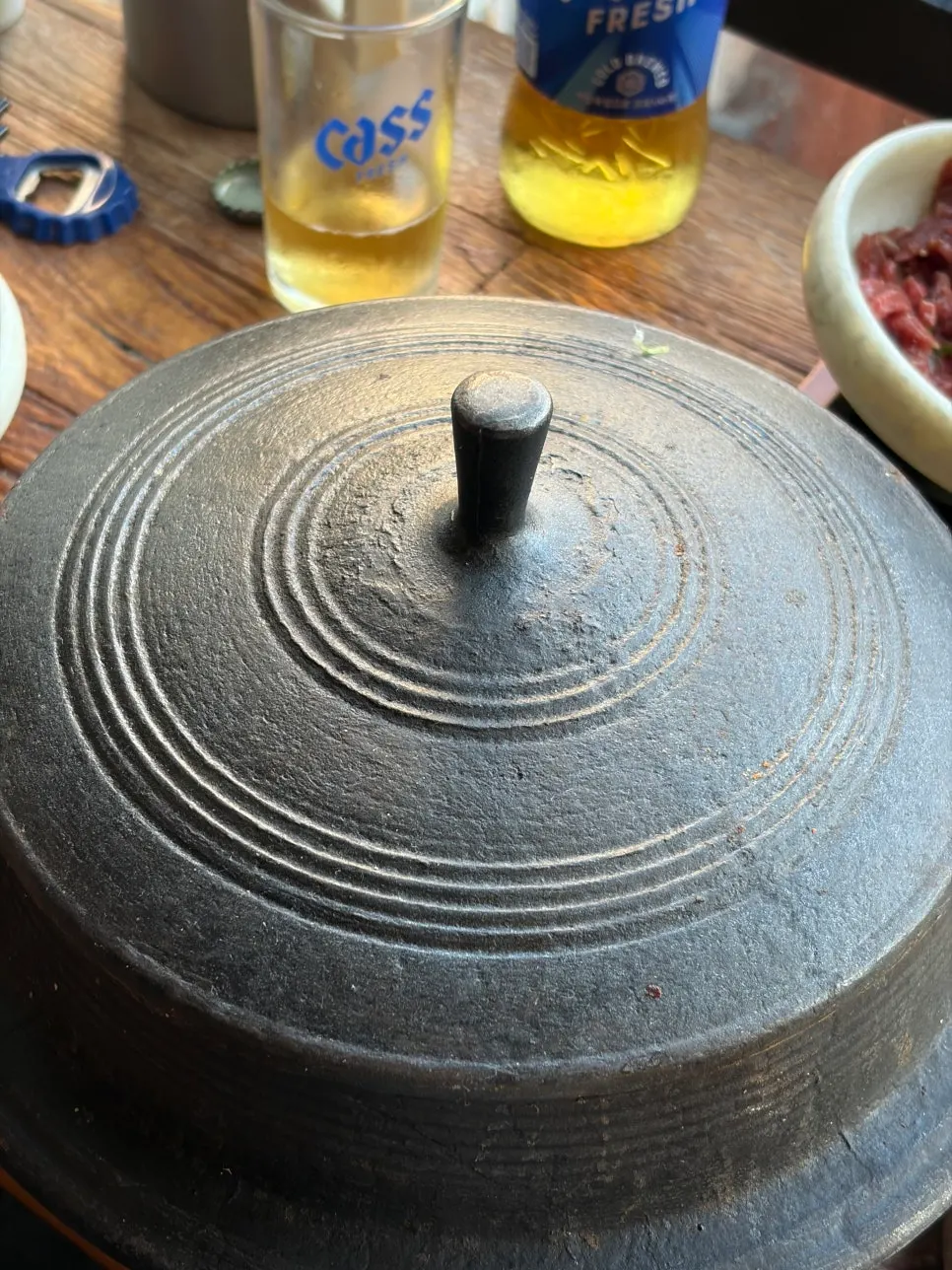 Straw-fire seared octopus served in a cauldron