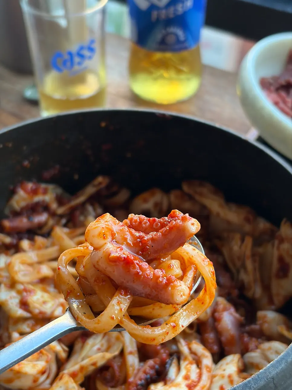 Spicy sauced octopus cut into pieces with scissors