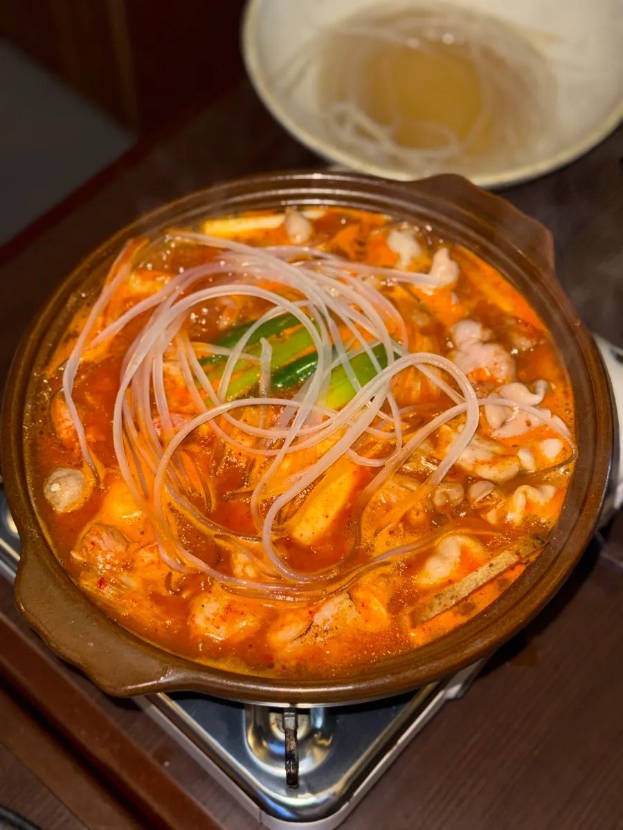Spicy rice cake gopchang stew simmering