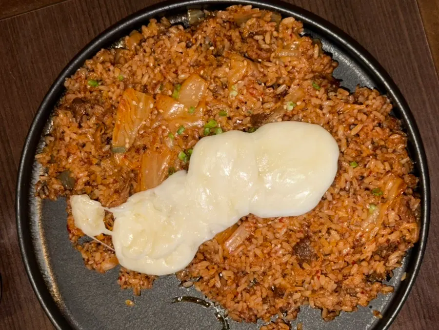Cheese poured over the kimchi fried rice