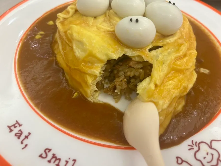 Taking a bite of rubber-duck omurice