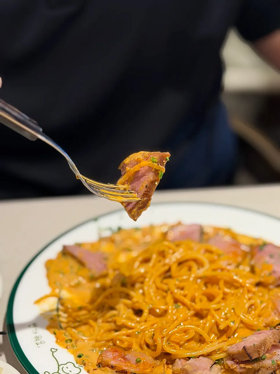 Meat served alongside gochujang butter pasta
