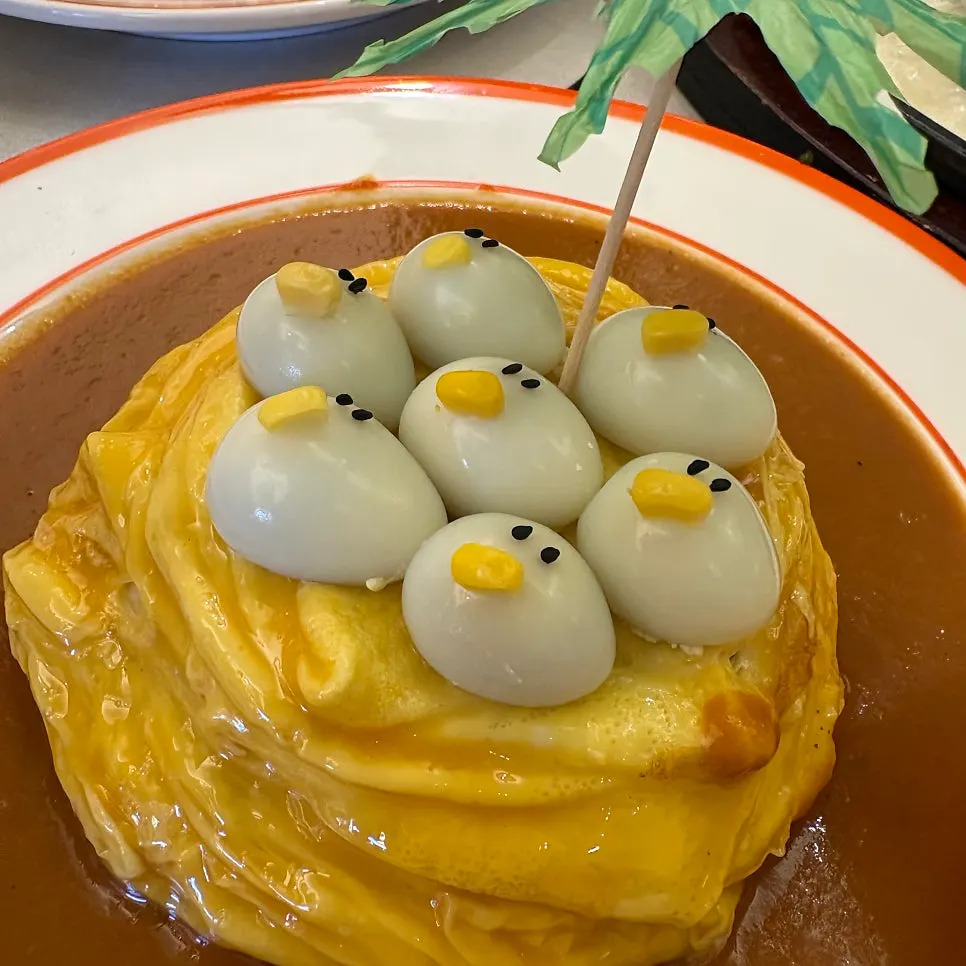 Sizzling cheese katsu bubbling on an iron plate at Omil