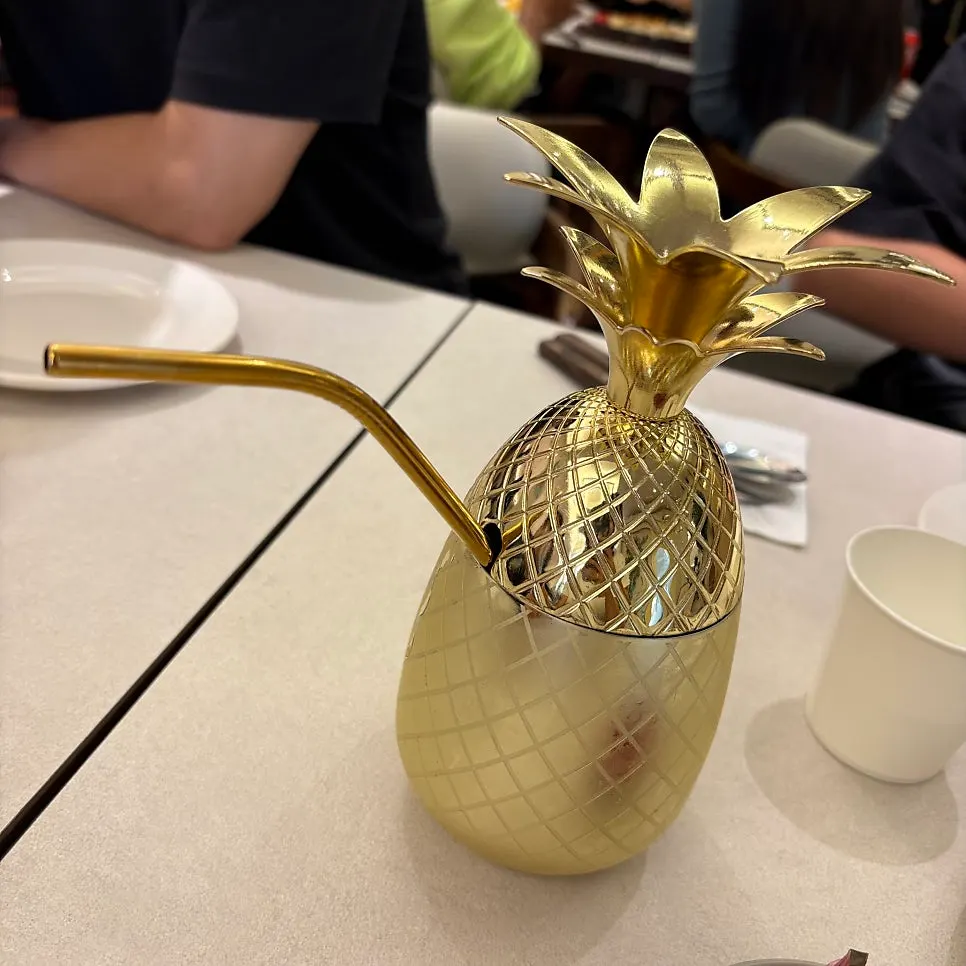 Pineapple juice served in a uniquely designed cup at Omil