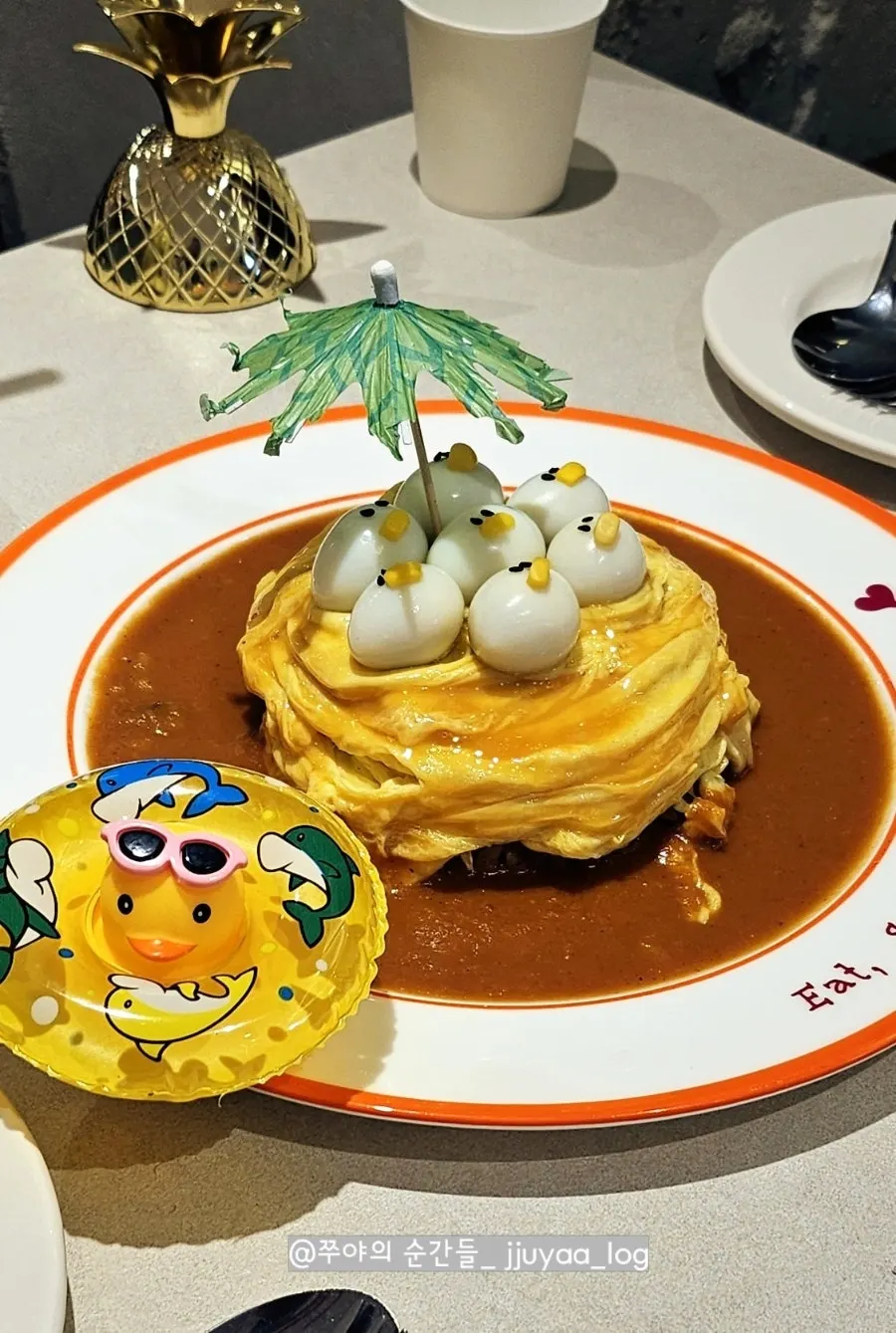 Swirl omurice topped with a rubber duck plush