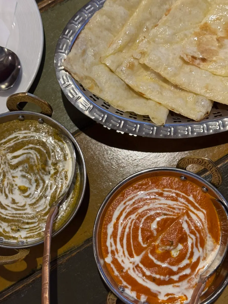 Palak paneer, butter chicken curry, and butter naan