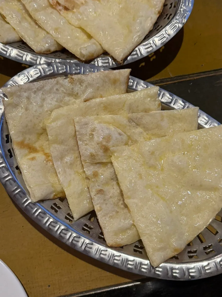 Freshly made butter naan cut into easy-to-eat pieces