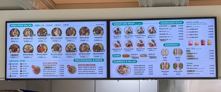 Menu board listing poke toppings and dishes